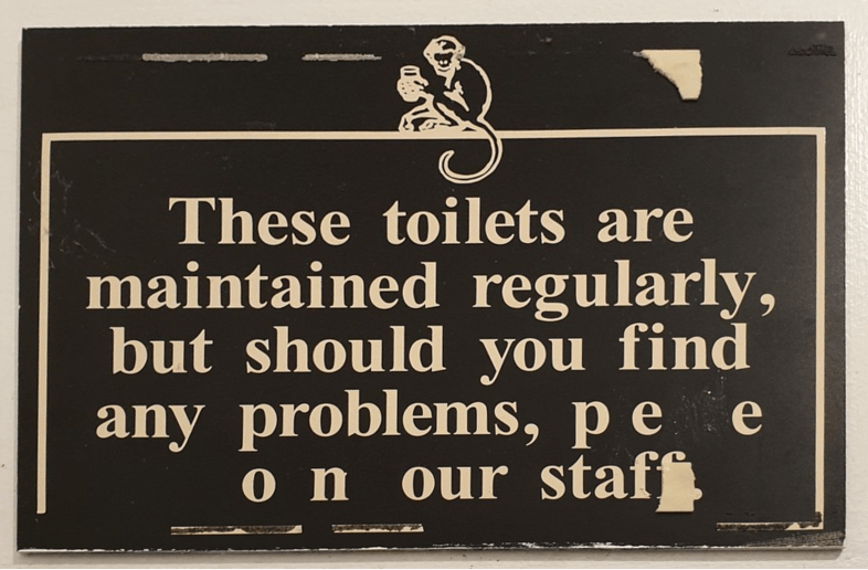 sign asking customers to speak to staff if toilets aren't maintained, but someone has vandalised the sign to say "pee on our staff."