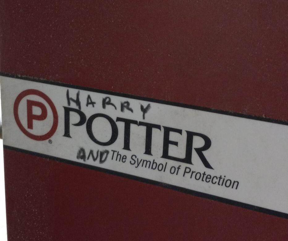 Potter sign that has been mildly vandalised to say "Harry Potter and the Symbol of Protection."