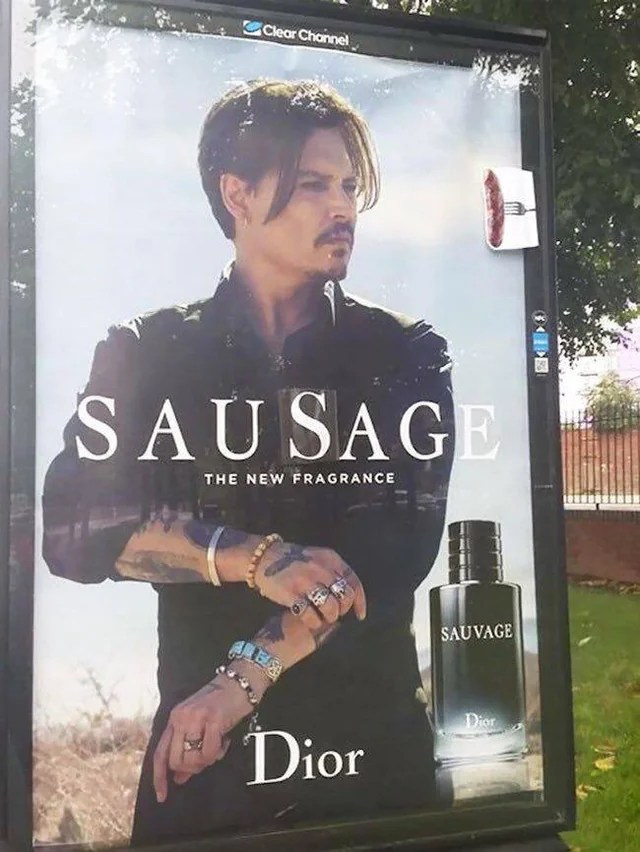 Johnny Depp in a Sauvage ad, but someone replaced the second S so it says Sausage.