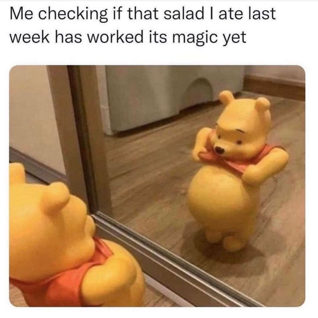 Winnie the pooh holding up his shirt to show his fat belly. Text says "me checking if that salad I ate last week has worked its magic yet."