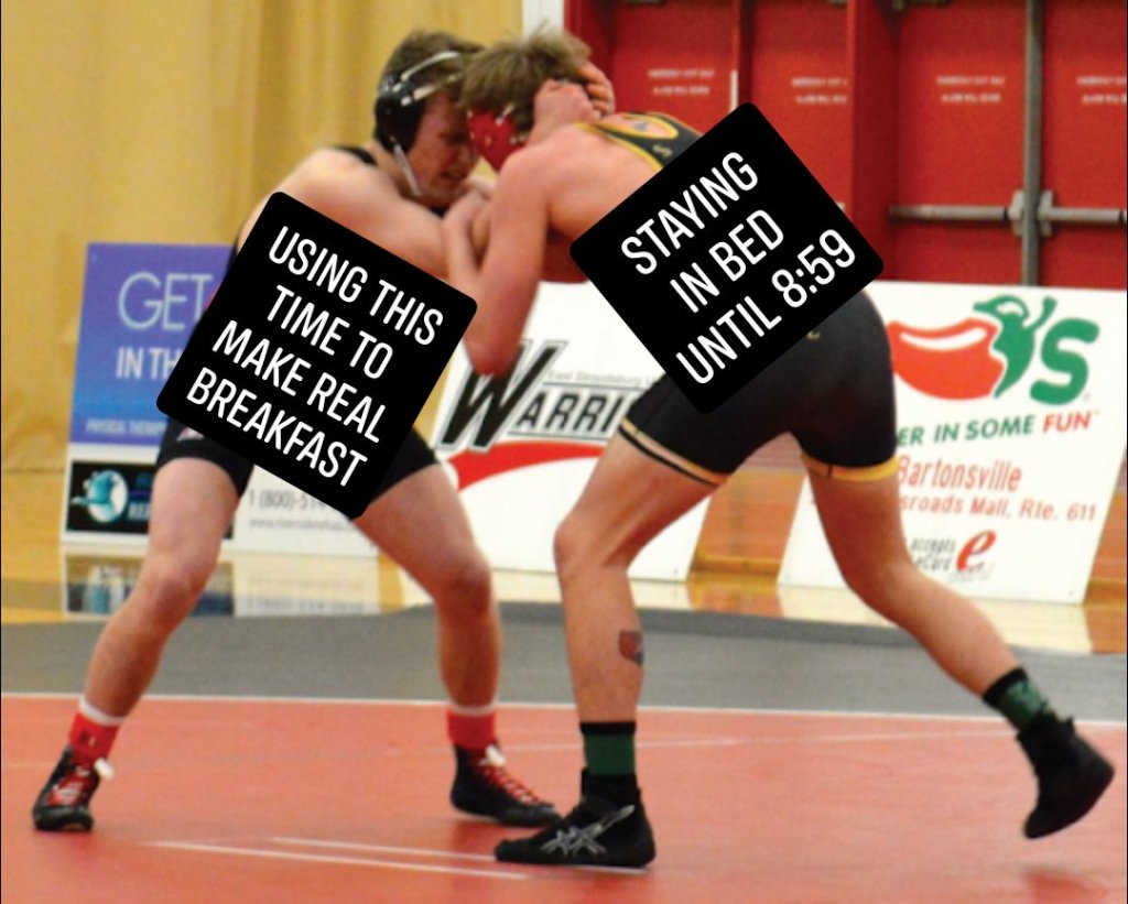 two men wrestling on a mat